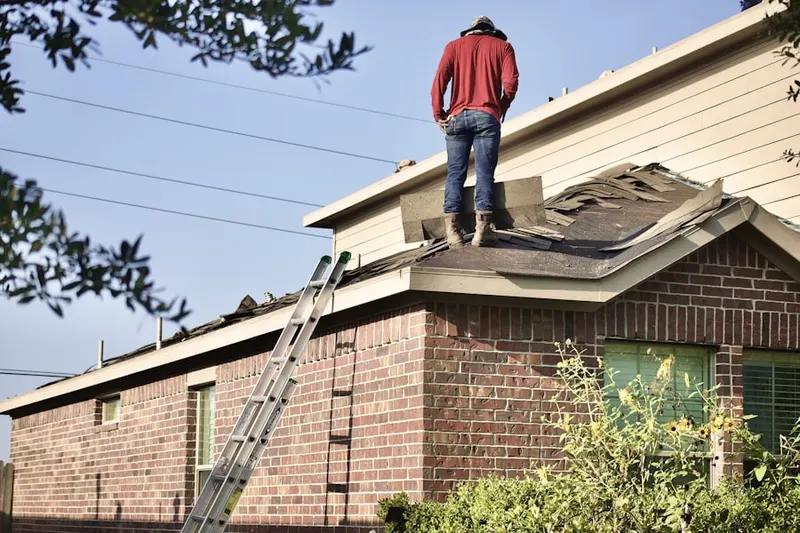 Professional roofer working on a residential roof in Natchez